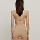 back of woman in tan bra and brief