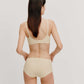 back of woman in light yellow bra and brief