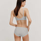 back of woman in light blue bra and brief