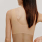 back of woman in beige bra and brief