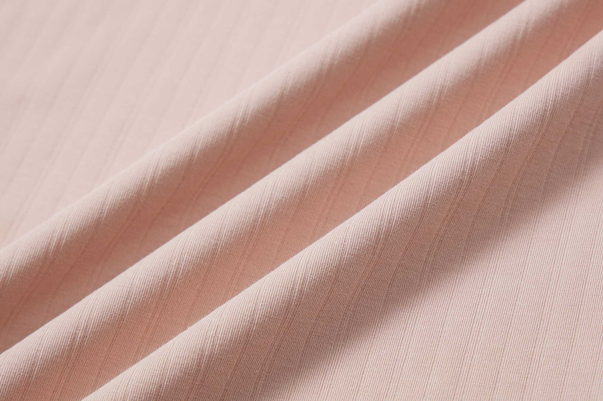 close up of pink cotton fabric with ribbed details