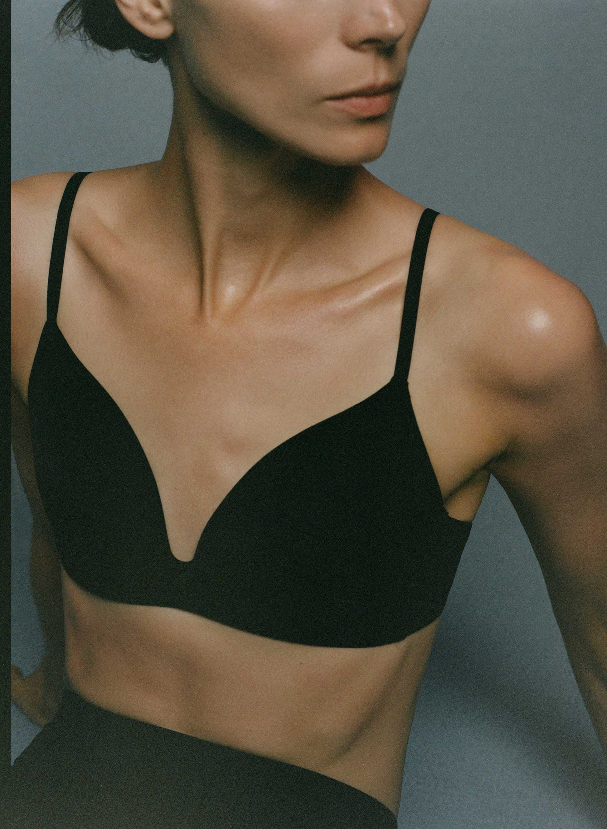 A woman wearing a black triangle bra