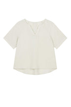 flat lay of light beige short sleeve v neckline tee