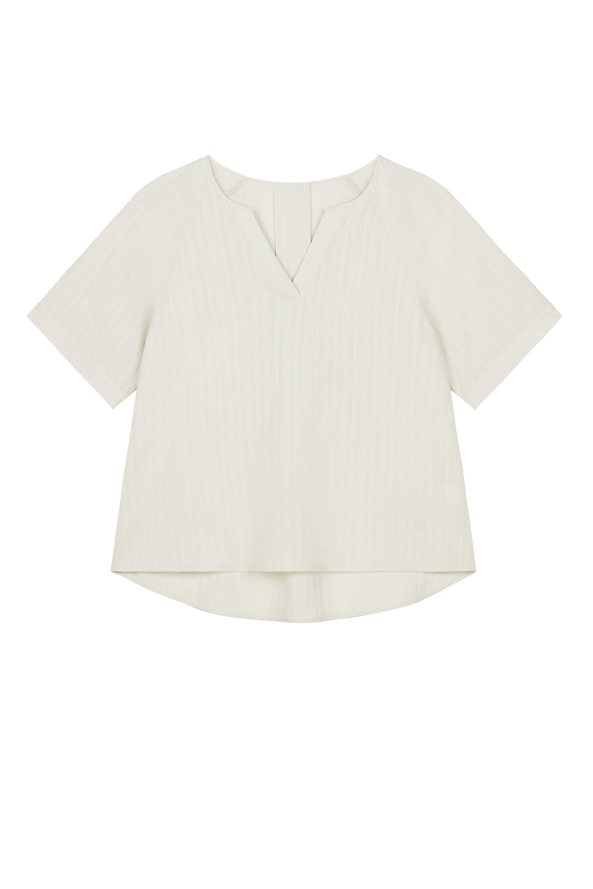 flat lay of light beige short sleeve v neckline tee