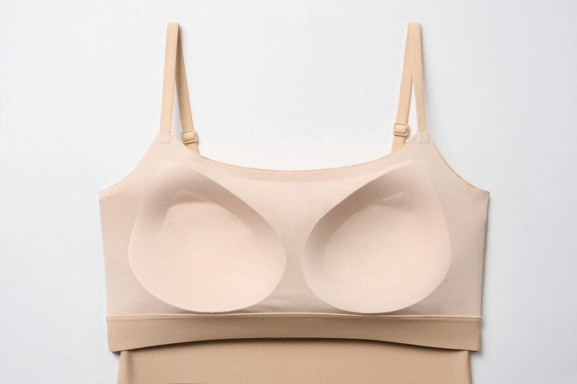 Interior view of built-in shelf bra of beige camisole