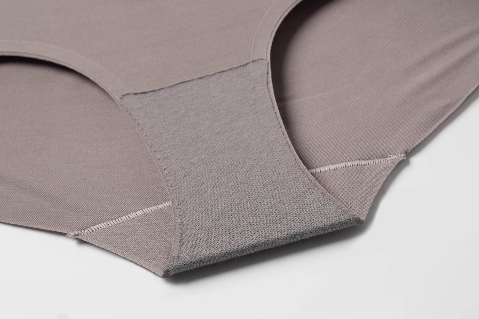 Close-up view of the inner lining and stitching details of a gray purple seamless brief, highlighting the soft fabric and precise construction.