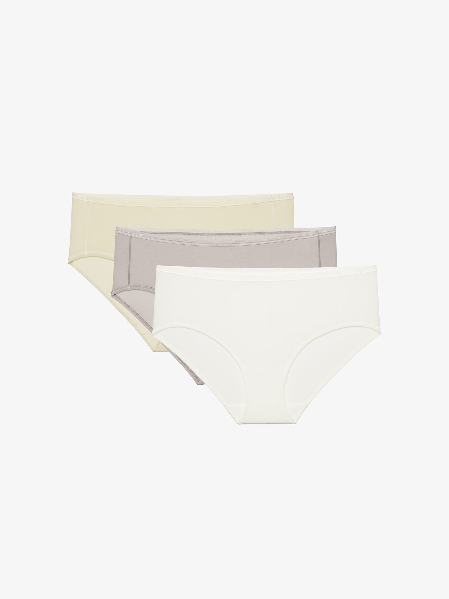 Flat lay of a beige brief, gray brief, and white brief stacked on top of one another