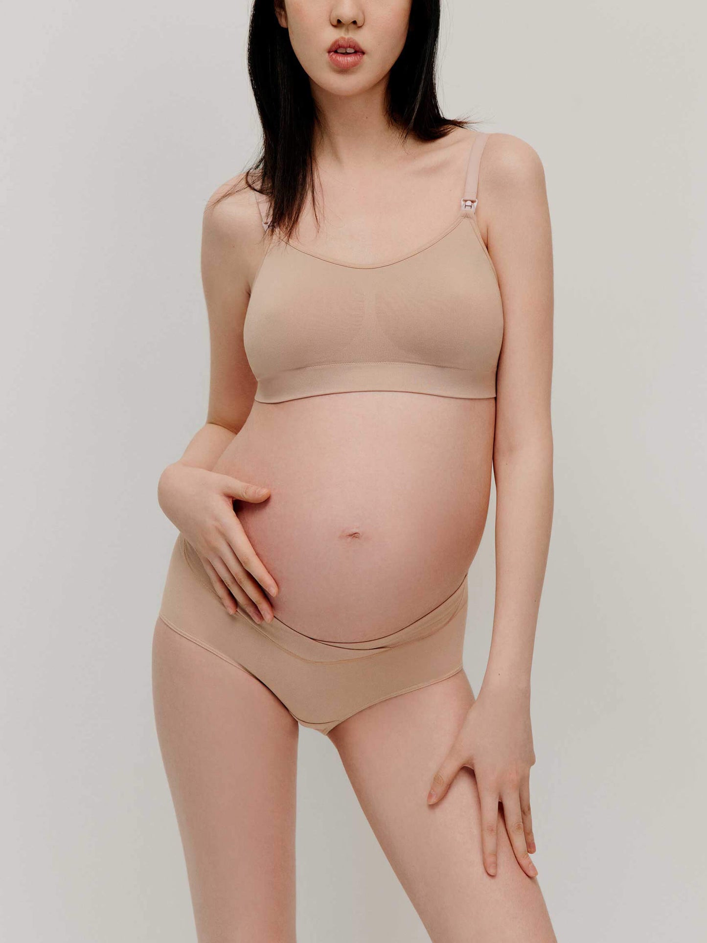 pregnant woman in nude color bra and underwear