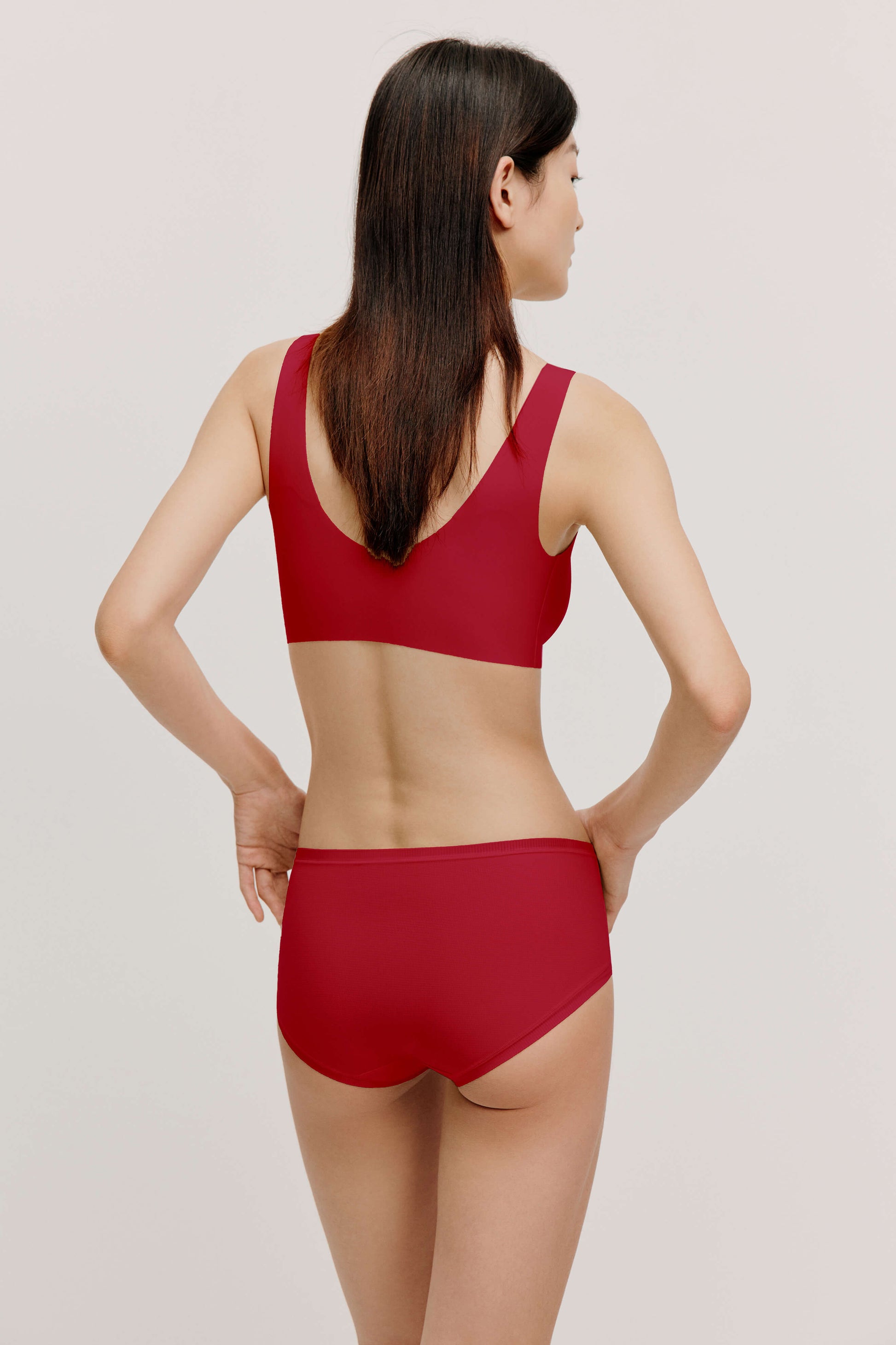 Back of woman wearing red bra and brief