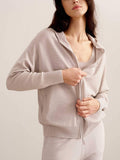 woman in light pink hoodie and joggers