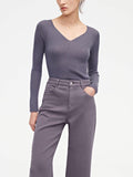 woman in purple v neck sweater