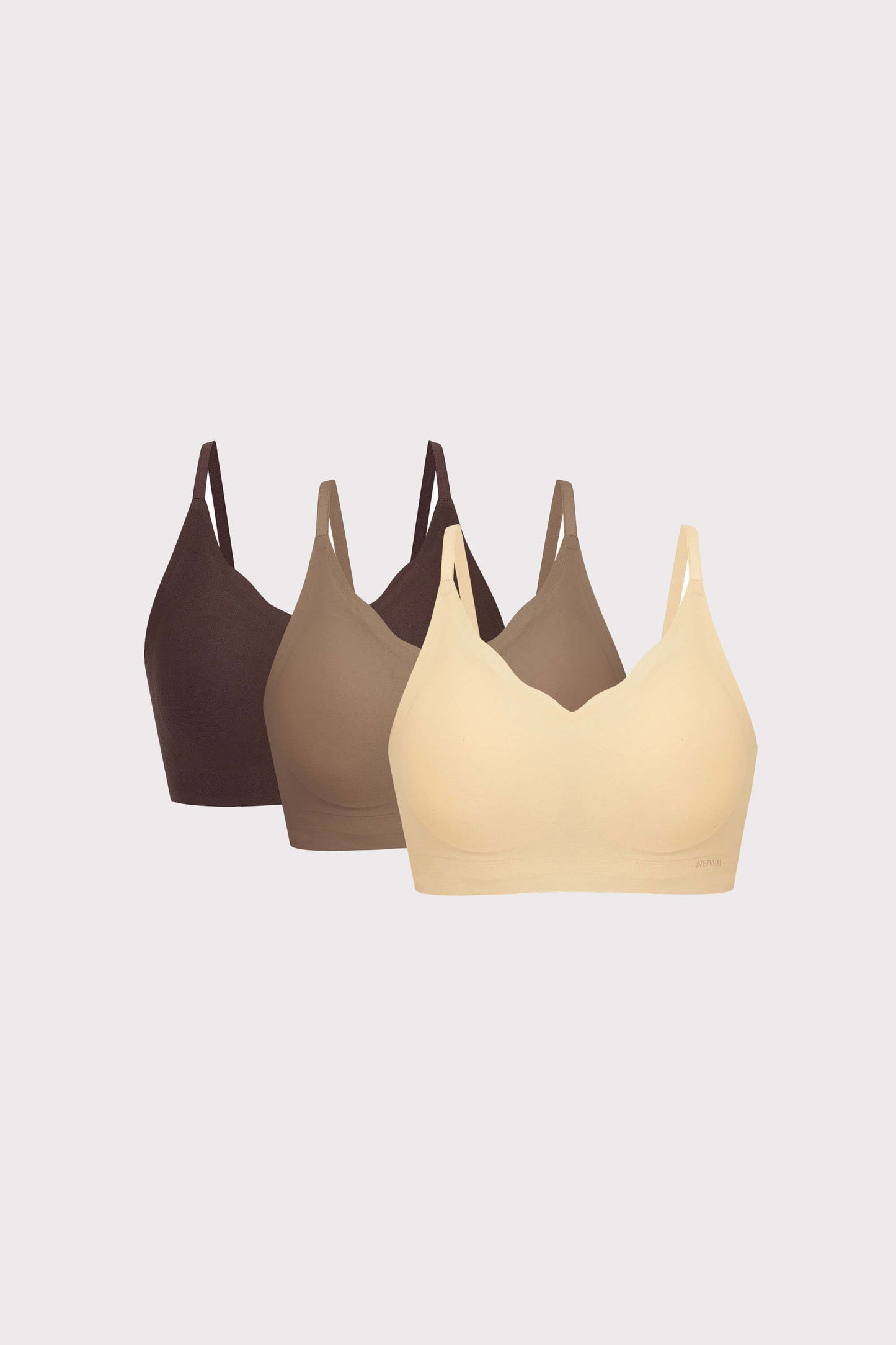 three bras in black, light brown and beige
