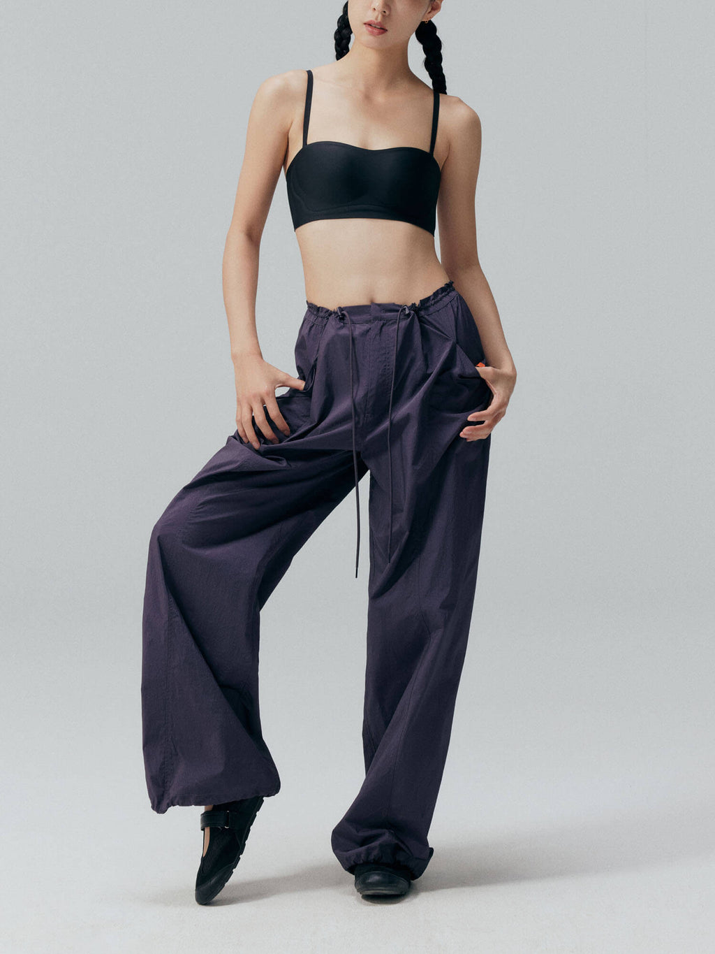 Model wearing black bandeau bra and navy blue pants. Black color.