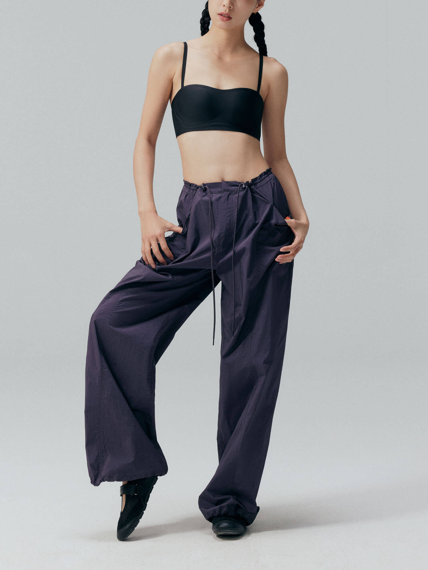 Model wearing black bandeau bra and navy blue pants. Black color.