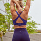 back of woman in woman in blue sports bra and leggings