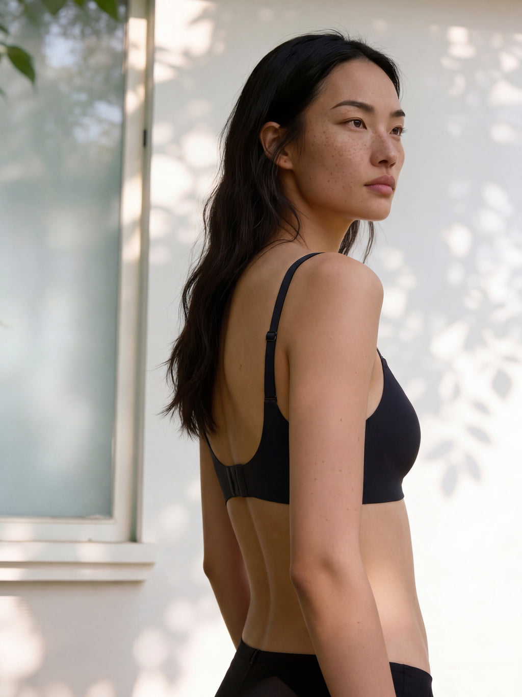 Woman wearing a black sports bra and leggings outdoors