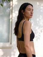 Woman wearing a black sports bra and leggings outdoors