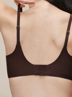 Brown bra worn by a person on a plain background