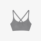 Flat lay of dark gray cross back sports bra