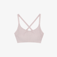 Flat lay of light pink cross back sports bra