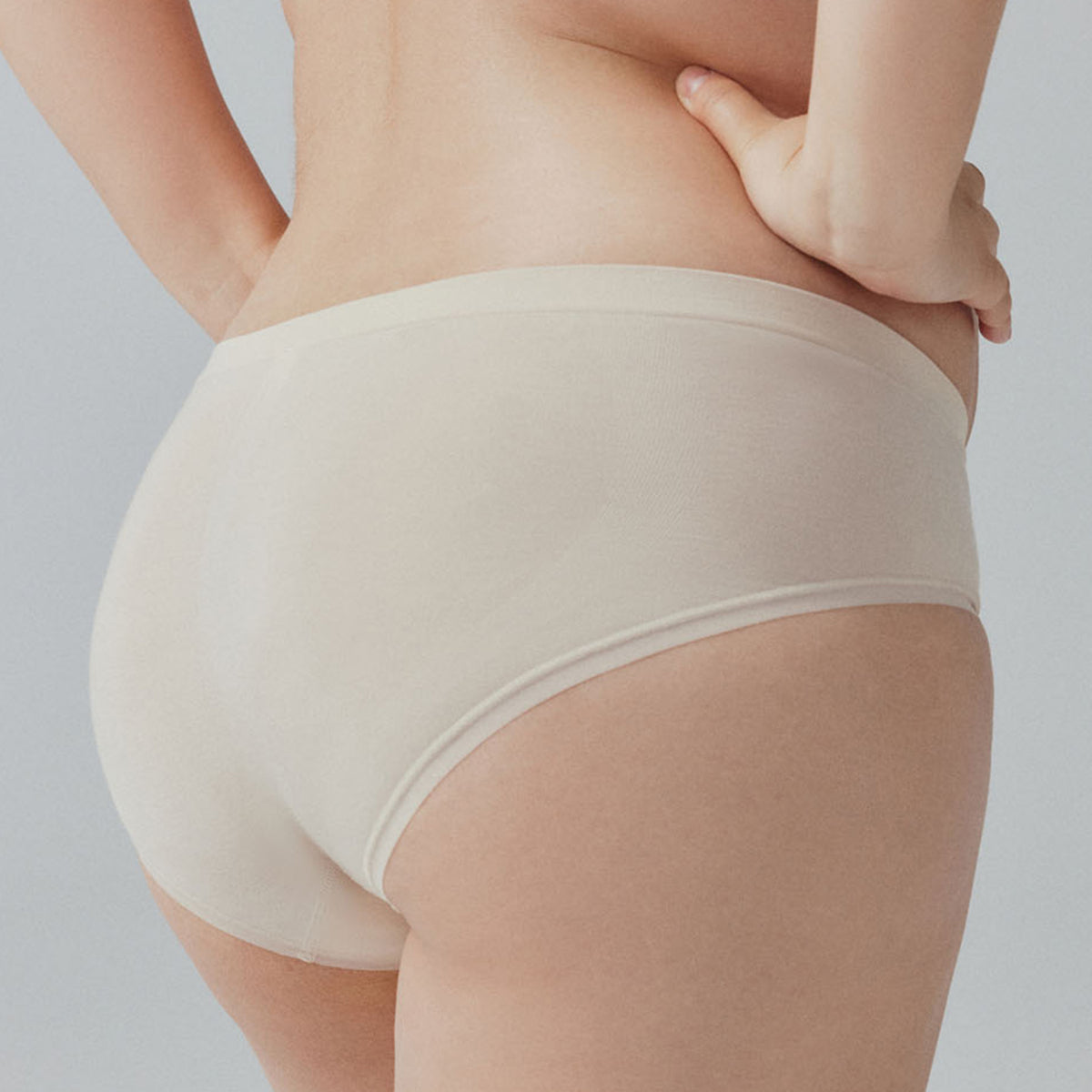 the back of a woman wearing a pair of off white panties.