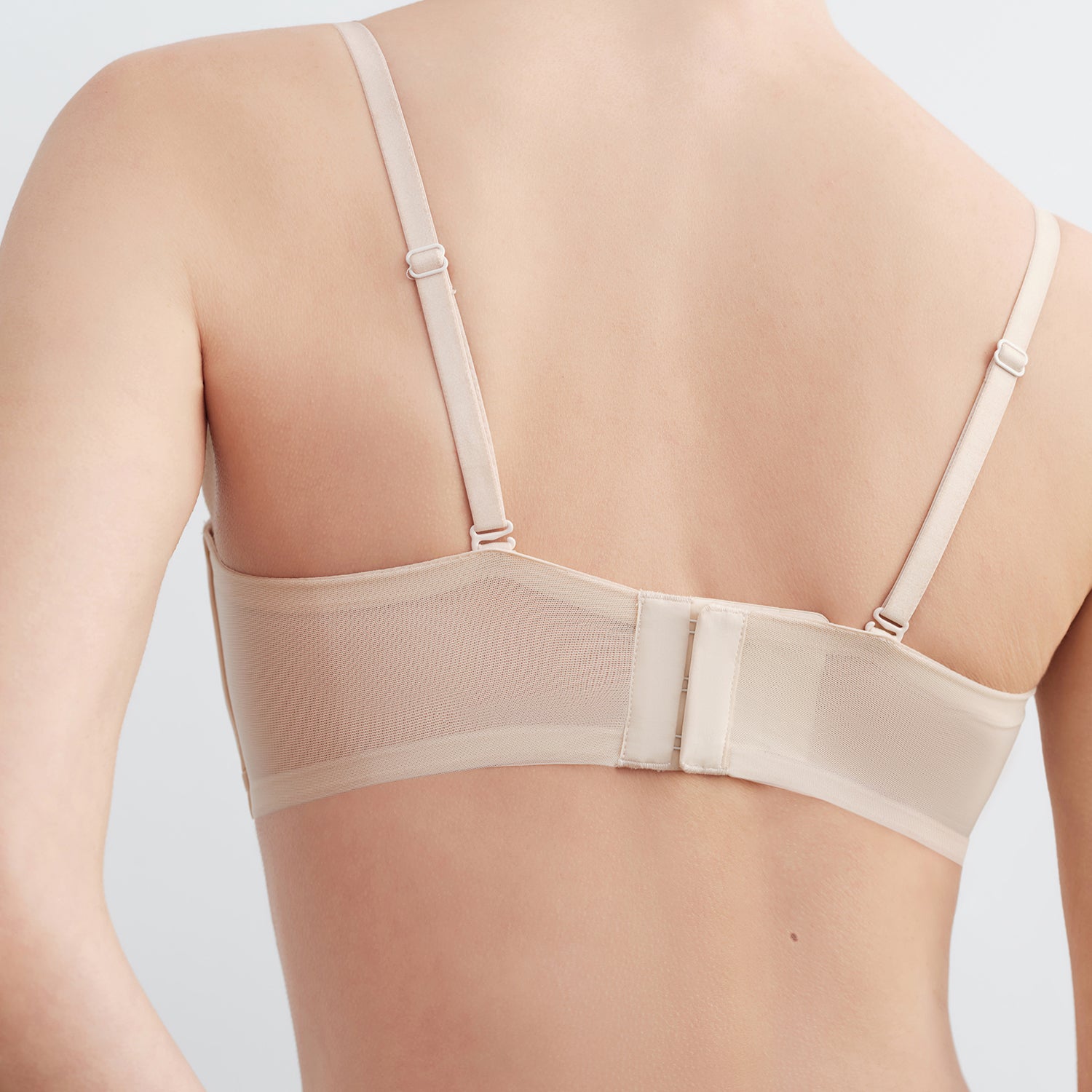 Beige bra on a plain background