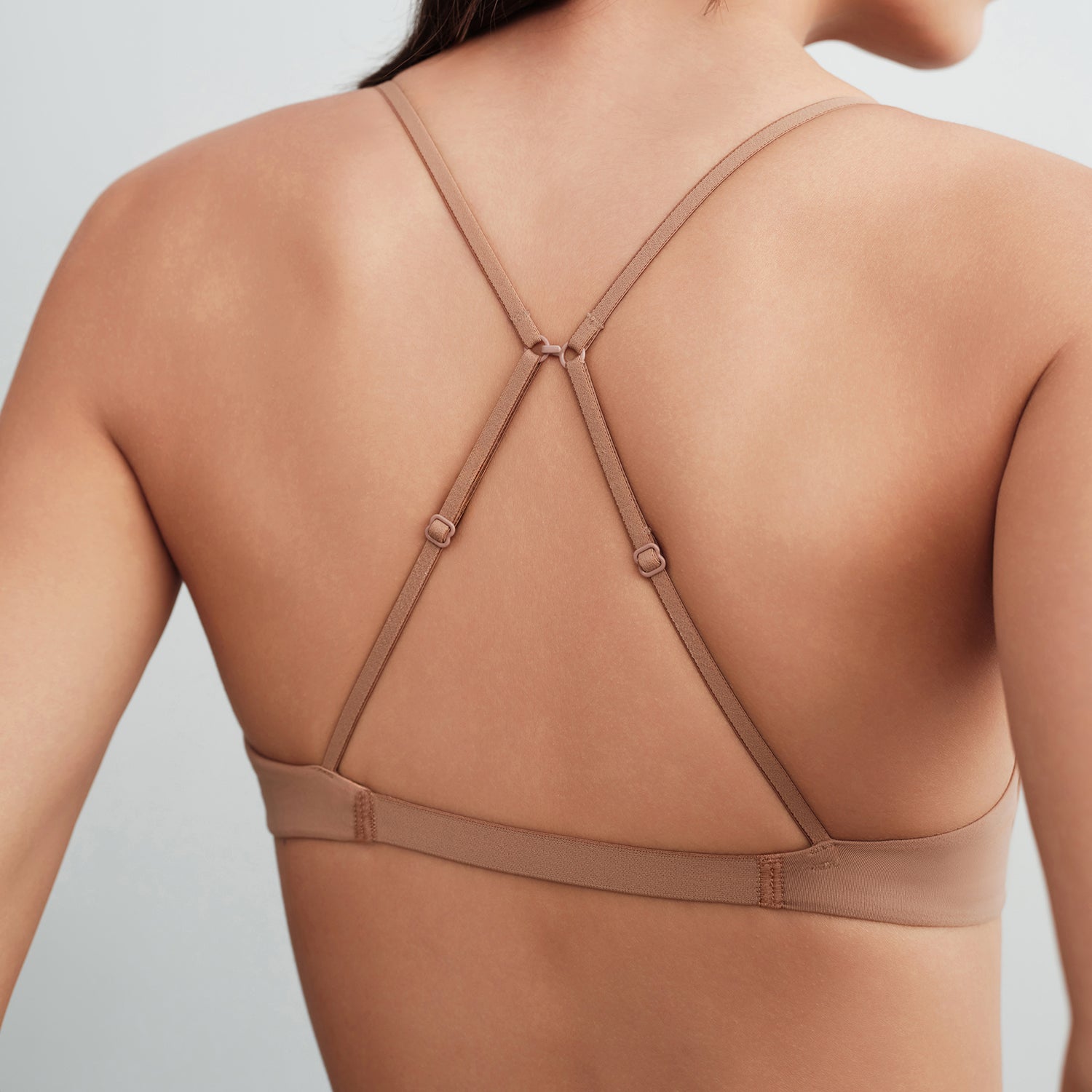 Nude-colored bra on a plain background