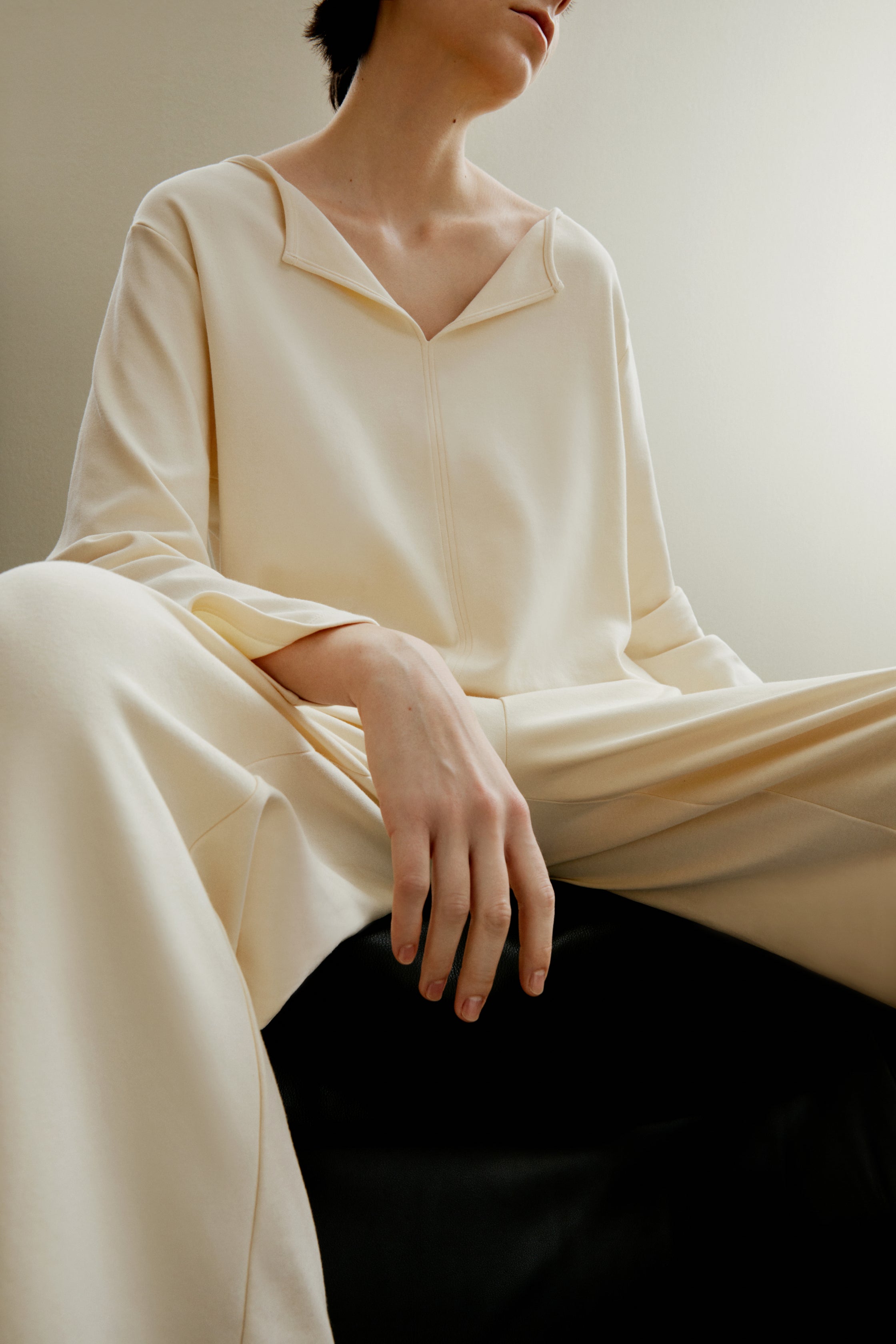 Woman in yellow top and pants.