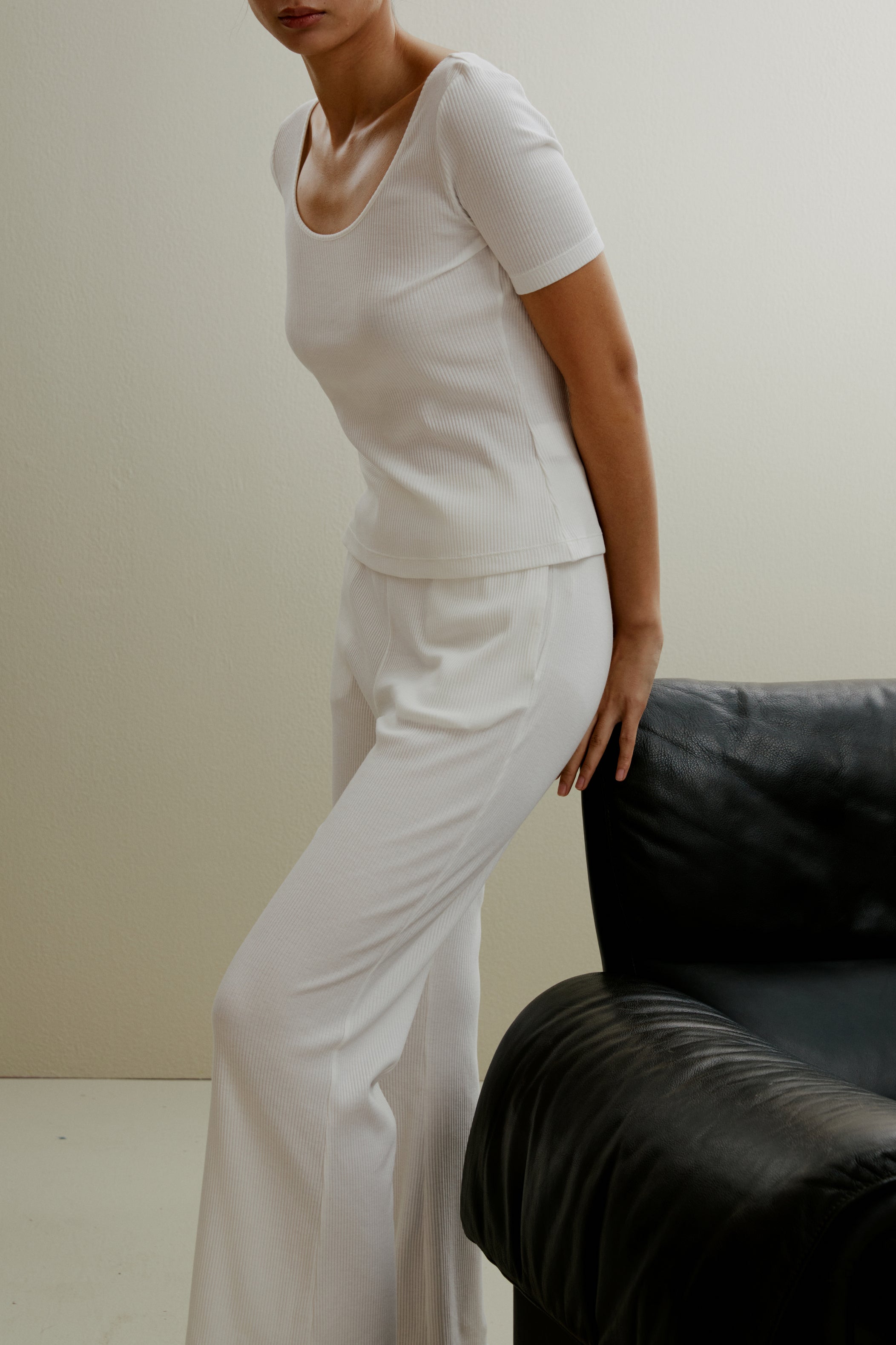 Women in the white ribbed pajama top and pants