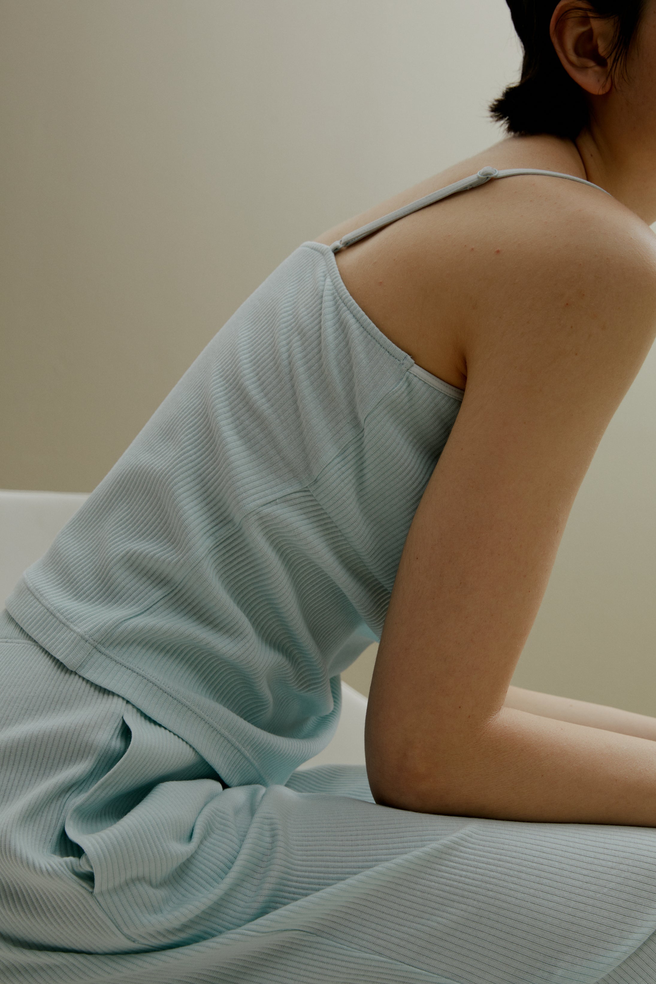 side of women in pale blue U-neck padded camisole