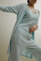 women in pale blue ribbed cardigan and pajamas set