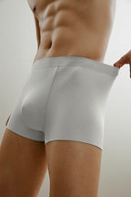 Bottom half of man wearing light gray boxer briefs made from ribbed fabric
