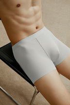 Bottom half of man wearing light gray boxer briefs made from ribbed fabric