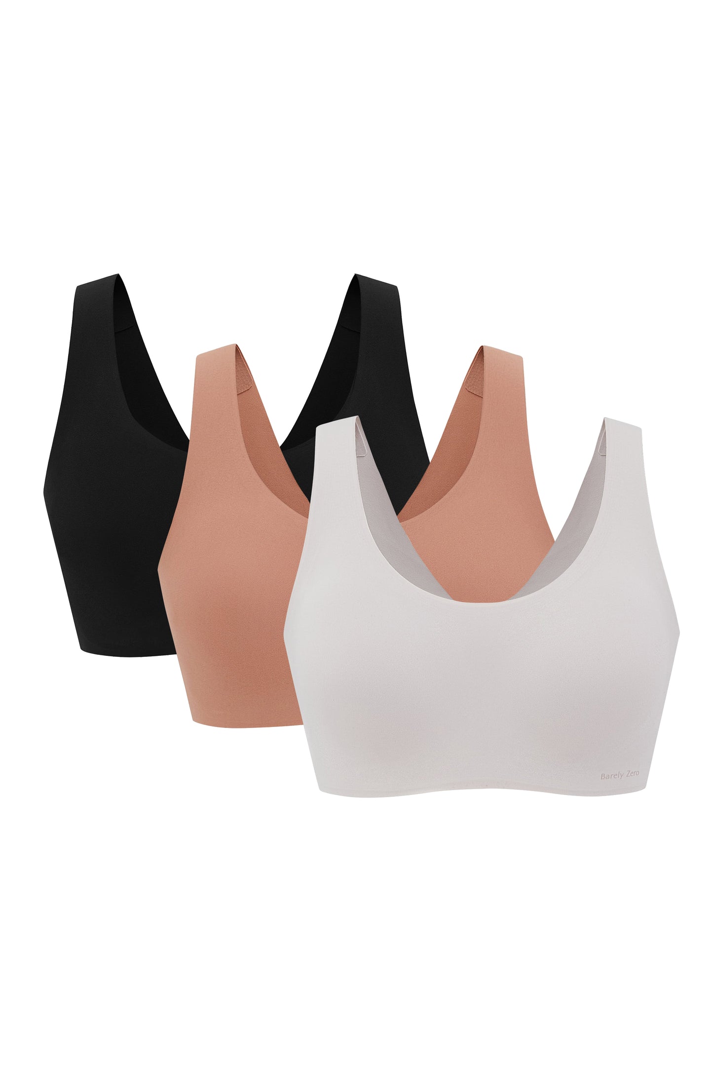 Three Barely Zero Classic Bra Trios in black, beige, and white, displayed against a white background. Each bra features a smooth, seamless design and a racerback cut.