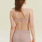 back of woman in light pink bra and brief