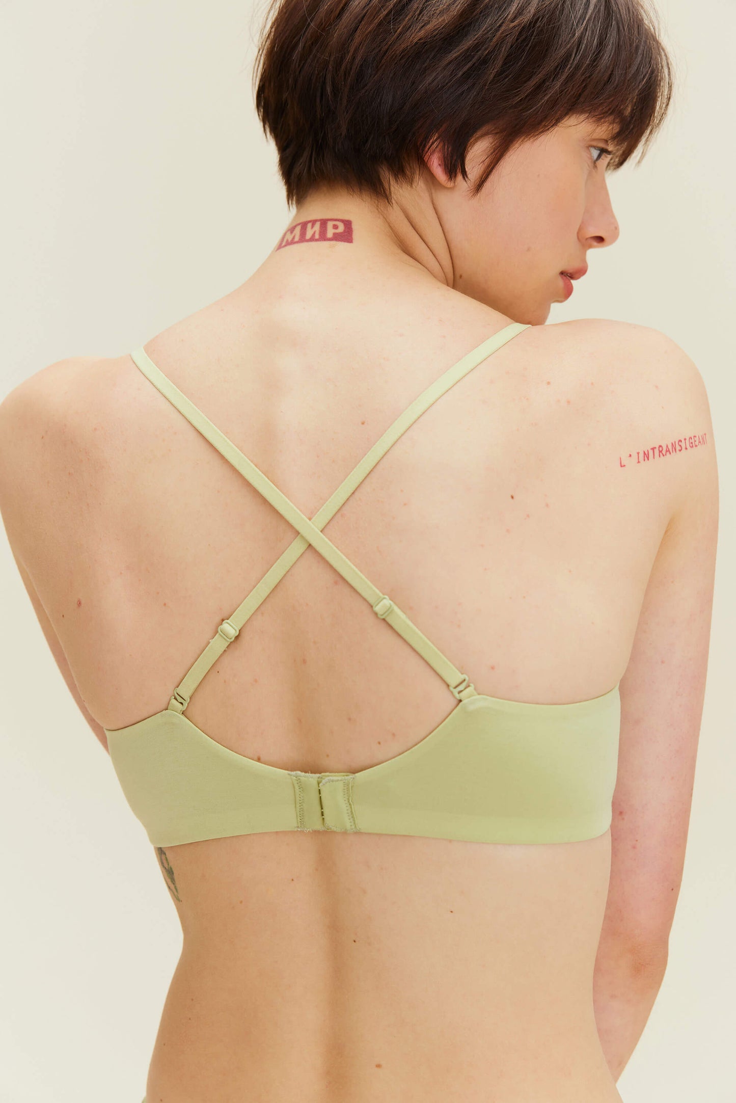 back of woman in green bra