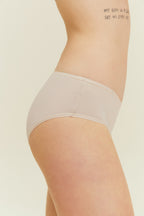 side of woman in beige brief