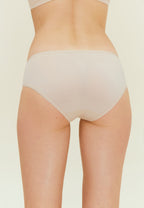 back of woman in beige brief