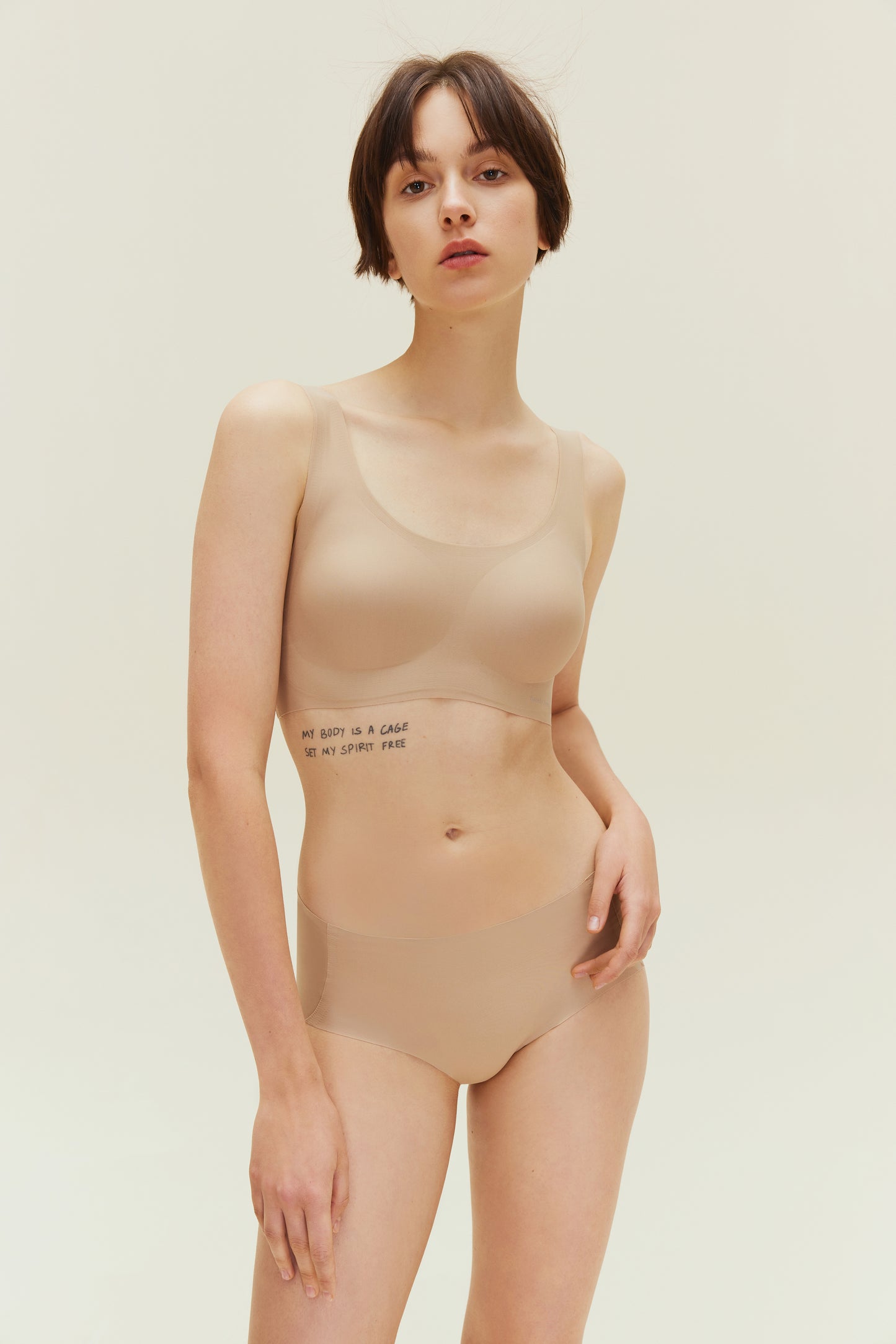 woman wearing nude color bra and brief