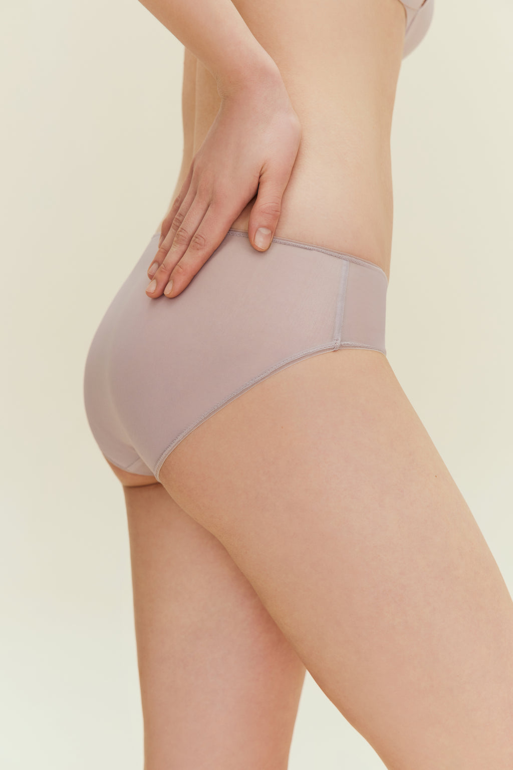 Side view of woman wearing taupe brief.