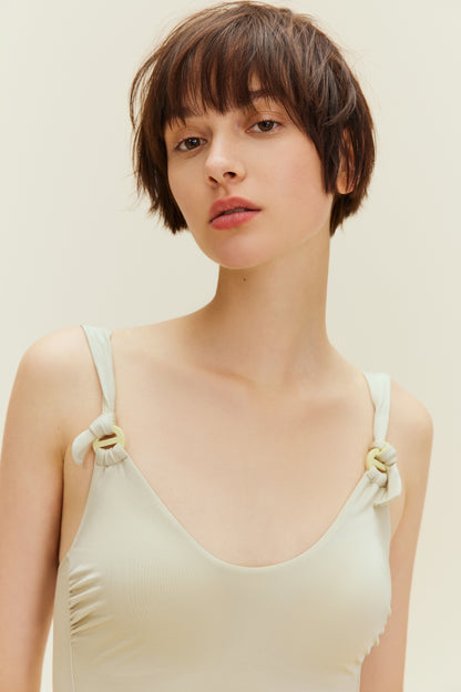 close up of woman in light golden swimsuit