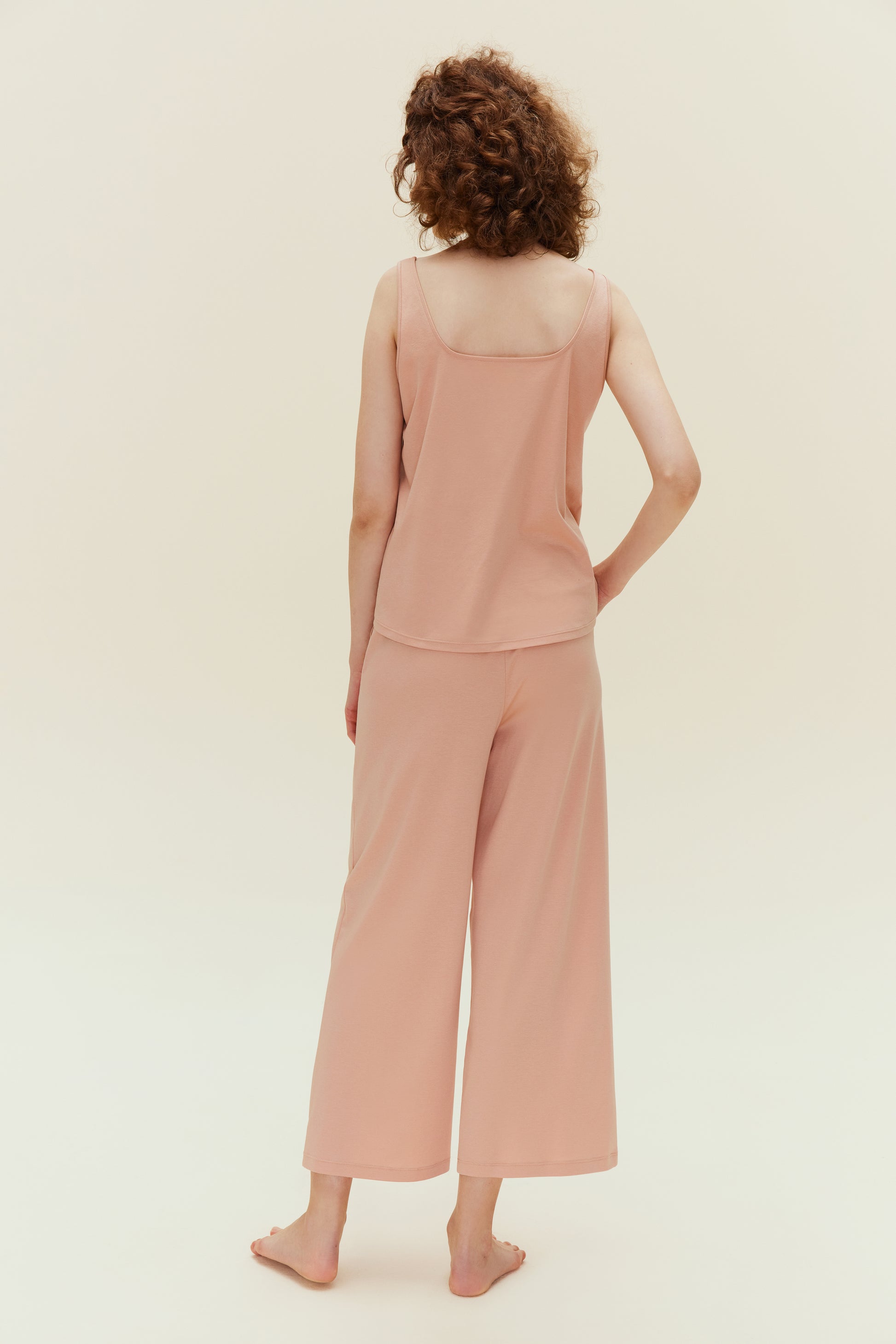 back of woman in pink jumpsuit