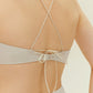 Close up view of back of gold bikini top with cross back straps