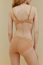 back of woman in orange bra and underwear