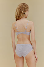 back of woman in blue bra and underwear