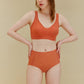 woman in orange bra and brief
