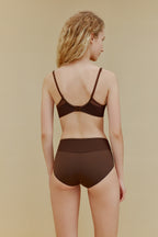 Back of woman in brown bra and panties