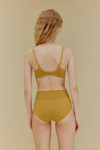 Back of woman in yellow bra and panties
