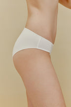 side of woman in white underwear