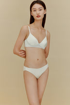 Woman in white silk bra and underwear